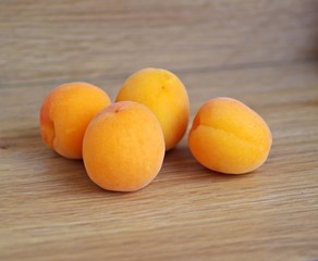 Fresh apricots on a wooden background. Organic apricot fruit.