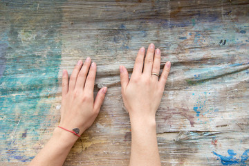 Female hands on the rough texture of the table