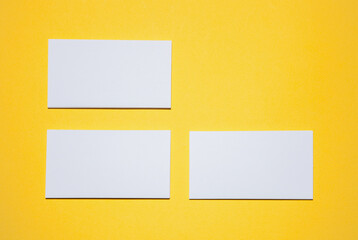 Empty business cards on yellow background