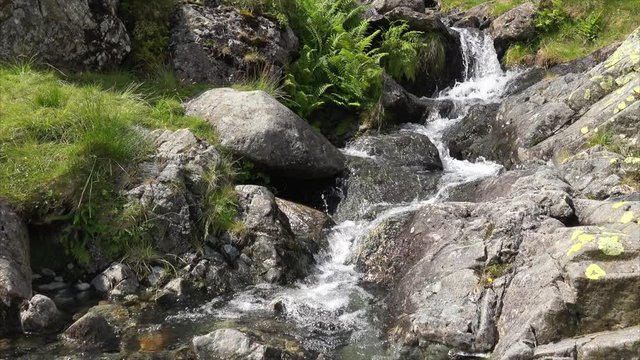 Cold water flowing down a mountain stream in the English Lake District.