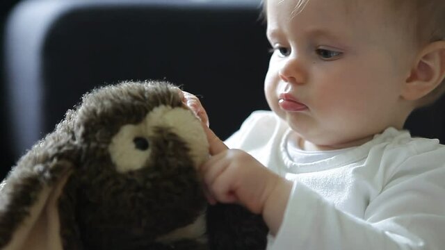 baby girl cuddling with a soft toy