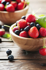 Red sweet strawberry and blueberry on the wooden table