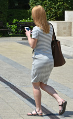 Young woman walks with a smartphone