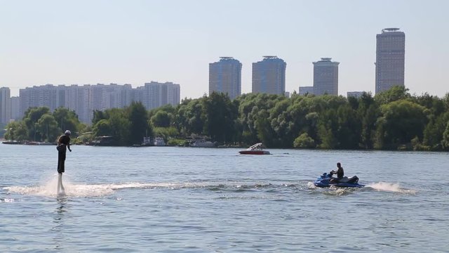 Flyboard. A man hovers over the water
