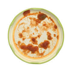 Dirty lid of chunky salsa sauce on a white background.