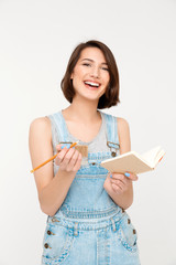 portrait of young laughing beautiful girl, holding notebook