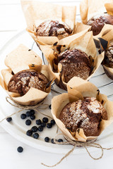 Chocolate banana muffins on white wooden background. Selective focus