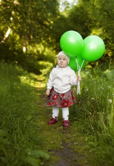 little girl with green balloons