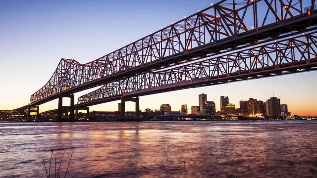 Crescent City Connection Bridge carries traffic over the Mississippi River into New Orleans at night, skyline timelapse