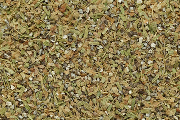 Organic dry True green cardamom (Elettaria cardamomum) tea cut seeds. Macro close up background texture. Top view.