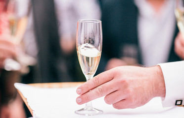 Professional male waiter in uniform serving champagne. DOF. Natural light. Photo in motion