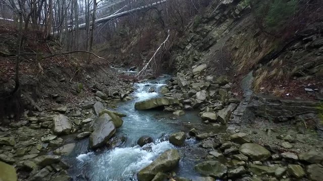 beautiful view of mountain stream flowing over cliffs in Carpathians
