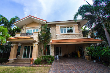 House with beautiful landscaping on a sunny day - Home exterior