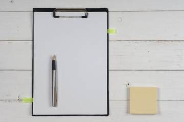 Business blank, notepad,  coffee cup and pen at office desk table top view. Corporate stationery branding mock-up