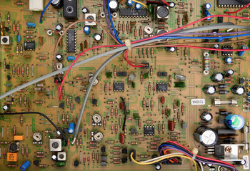 Top view of a circuit board with electrical components and colored cords