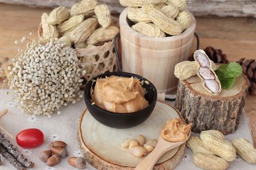 Fototapeta na wymiar Peanut butter and peanut on wood background.