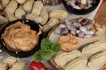 Obraz na płótnie Canvas Peanut butter and peanut on wood background.