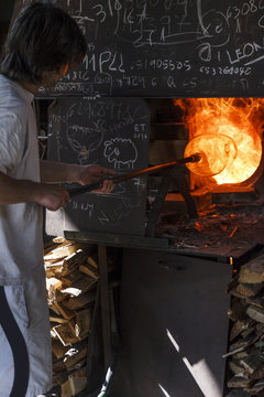 Man using a furnace in a glass factory