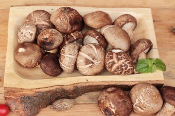 Fototapeta premium Shiitake mushrooms for cooking on wood background.