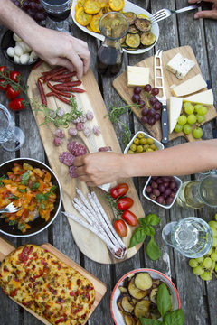 People enjoying variety of Mediterranean antipasti