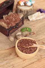 Flax seeds for health on wood background.