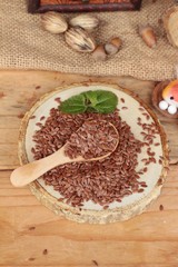 Flax seeds for health on wood background.