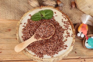 Flax seeds for health on wood background.