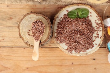 Flax seeds for health on wood background.