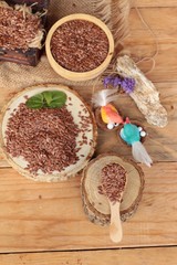 Flax seeds for health on wood background.