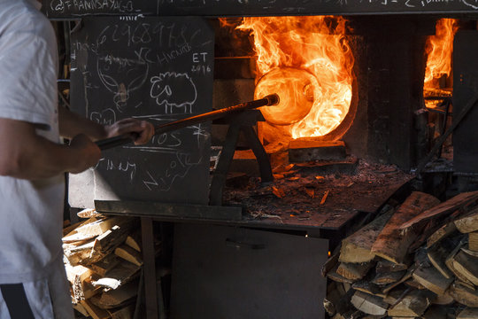 Man using a furnace in a glass factory
