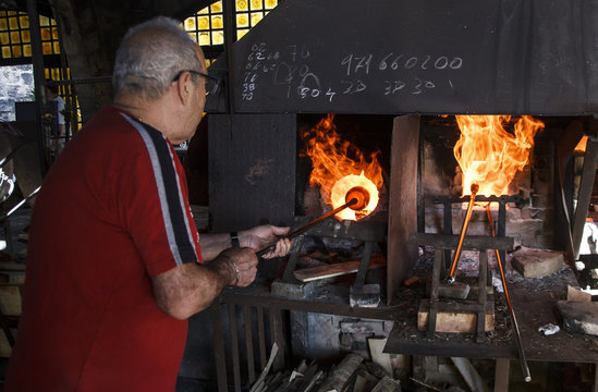 Man using a furnace in a glass factory in Mallorca