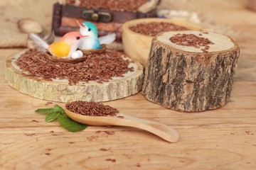 Flax seeds for health on wood background.