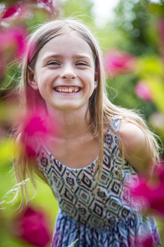 Portrait of happy girl with tooth gap in the garden