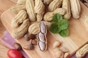 Peanut and boiled peanuts on wood background.