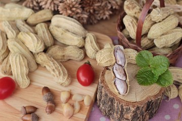 Peanut and boiled peanuts on wood background.