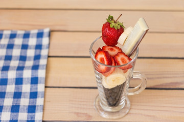 fruit cocktail blueberry banana strawberry on a wooden background