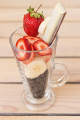fruit cocktail blueberry banana strawberry on a wooden background