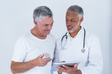 doctor showing reports to senior man