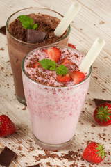 chocolate and strawberry milkshake on wooden background