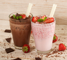 chocolate and strawberry milkshake on wooden background