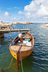 Old fishing boat at a rocky coastline