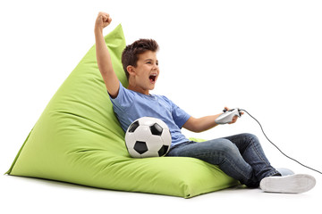 Joyful kid playing football video game