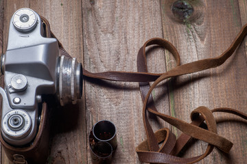 Old retro camera on vintage wooden boards abstract background. Copy space for text
