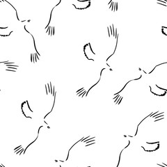 Seamless pattern with freehand ravens. Vector illustration of flying crow. Grunge ink painting. Black and white wallpaper