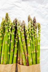 Asparagus in paper bag on white