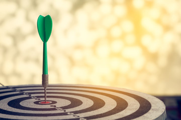 dart arrow hitting in the target center of dartboard,abstract of