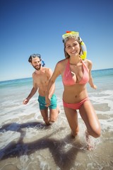 Couple running in water