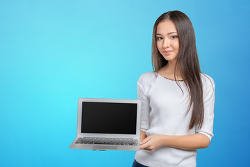 portrait of beautiful young woman holding laptop isolated