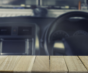 wood table top on blur background of inside car