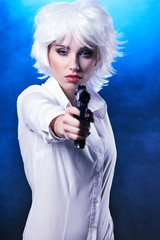 beautiful sexy girl holding gun . smoke background